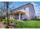 Exterior of two-story home with a covered patio, a green lawn, and some trees nearby at 1722 Lake Sims Pkwy, Ocoee, FL 34761