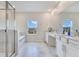 Bright bathroom featuring double sinks, a large mirror, a shower, and soaking tub at 1722 Lake Sims Pkwy, Ocoee, FL 34761