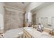 Bathroom featuring double sinks, a tile backsplash, tub-shower, and a large mirror at 1722 Lake Sims Pkwy, Ocoee, FL 34761