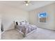 Cozy bedroom featuring carpet, a ceiling fan, window and furniture at 1722 Lake Sims Pkwy, Ocoee, FL 34761