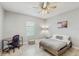 Bright bedroom with a ceiling fan, natural light, and a desk area, offering a comfortable living space at 1722 Lake Sims Pkwy, Ocoee, FL 34761