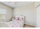 Bedroom featuring a bed with pink and white bedding and a window with blinds at 1722 Lake Sims Pkwy, Ocoee, FL 34761