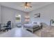 Well-lit bedroom with ceiling fan and work space at 1722 Lake Sims Pkwy, Ocoee, FL 34761