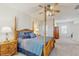 Bedroom showcasing a wooden four-poster bed with blue bedding and carpeted floors at 1722 Lake Sims Pkwy, Ocoee, FL 34761