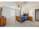 Spacious bedroom featuring a four-poster bed, ceiling fan, and neutral walls at 1722 Lake Sims Pkwy, Ocoee, FL 34761