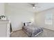 Neutral bedroom featuring light grey bedding, carpeted floors, and a window at 1722 Lake Sims Pkwy, Ocoee, FL 34761