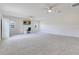 Spacious carpeted bonus room with ceiling fans and ample lighting at 1722 Lake Sims Pkwy, Ocoee, FL 34761