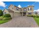 Inviting two-story home with a well-manicured lawn and three-car garage at 1722 Lake Sims Pkwy, Ocoee, FL 34761
