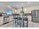 Stylish kitchen featuring stainless steel appliances, white cabinets, and island seating at 1722 Lake Sims Pkwy, Ocoee, FL 34761