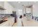 Bright kitchen featuring white cabinetry, stainless steel appliances, and an island with pendant lighting at 1722 Lake Sims Pkwy, Ocoee, FL 34761