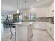 Modern kitchen with white cabinets, an island with seating, and an open floor plan at 1722 Lake Sims Pkwy, Ocoee, FL 34761