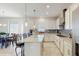 Bright, open kitchen featuring white cabinets, a center island, and modern appliances at 1722 Lake Sims Pkwy, Ocoee, FL 34761