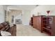 Spacious living room featuring tile floors, comfortable leather sofa, and elegant wood shelving at 1722 Lake Sims Pkwy, Ocoee, FL 34761