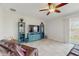 Inviting living room with a ceiling fan, stylish furniture, and natural light from the sliding glass door at 1722 Lake Sims Pkwy, Ocoee, FL 34761