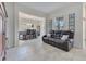 Open-concept living room with a leather sofa and dining area at 1722 Lake Sims Pkwy, Ocoee, FL 34761