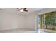 Bright living room with ceiling fan and sliding glass doors to the outdoor patio at 1722 Lake Sims Pkwy, Ocoee, FL 34761
