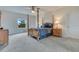 Spacious main bedroom featuring a four-poster bed, ceiling fan, and bright window at 1722 Lake Sims Pkwy, Ocoee, FL 34761