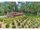 Stone sign for Arden Park community surrounded by landscaping and various plant life at 1722 Lake Sims Pkwy, Ocoee, FL 34761