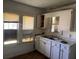 Modest kitchen featuring white cabinets, laminate countertops, and a double sink at 1803 S Westmoreland Dr, Orlando, FL 32805