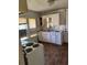 Modest kitchen featuring white cabinets, laminate countertops, and an electric stove at 1803 S Westmoreland Dr, Orlando, FL 32805