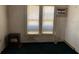 A small empty living room with two windows and a heater at 1803 S Westmoreland Dr, Orlando, FL 32805