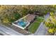 Aerial view of a home with a backyard pool, manicured lawn, and mature trees in a fenced yard at 1818 S Oak Ave, Sanford, FL 32771