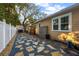 Backyard patio area with gravel, stone pavers, storage shed, barbecue grill, and lush landscaping at 1818 S Oak Ave, Sanford, FL 32771