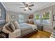 Comfortable bedroom featuring a ceiling fan, hardwood flooring, and natural light from the window at 1818 S Oak Ave, Sanford, FL 32771