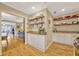 Bright kitchen pantry area featuring floating shelves and ample cabinet space at 1818 S Oak Ave, Sanford, FL 32771