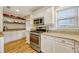 Kitchen featuring stainless steel appliances, granite countertops, and open shelving at 1818 S Oak Ave, Sanford, FL 32771