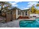 Backyard pool with spa steps, stamped concrete patio, and lush landscaping near the home at 1818 S Oak Ave, Sanford, FL 32771