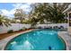 Backyard pool and patio with lounge seating, bordered by mulch beds and a white privacy fence at 1818 S Oak Ave, Sanford, FL 32771