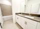 Bathroom featuring dual-sink vanity with tiled backsplash, and a separate water closet at 1883 Blissful Dr, Kissimmee, FL 34744