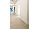 Inviting hallway with neutral tile flooring, leading to various rooms in the home and offering a seamless transition at 1883 Blissful Dr, Kissimmee, FL 34744