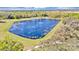 Aerial view of a tranquil pond surrounded by lush landscaping and walking path at 1883 Blissful Dr, Kissimmee, FL 34744