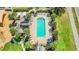 Aerial view of a rectangular community pool with many lounge chairs surrounded by palm trees at 215 Elderberry Dr, Davenport, FL 33897