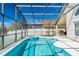 Sparkling screened-in pool with adjacent spa for ultimate relaxation and outdoor enjoyment in a private setting at 215 Elderberry Dr, Davenport, FL 33897