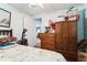 Bright bedroom featuring a bed, wooden wardrobe, dresser, and blue walls at 24813 E Highway 316, Salt Springs, FL 32134