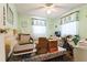 Green bedroom featuring a bed, desk, two windows, and floral curtains at 24813 E Highway 316, Salt Springs, FL 32134