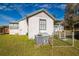 View of the side of the home, showing the AC, side entrance and carport at 24813 E Highway 316, Salt Springs, FL 32134