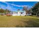 Cozy house with a blue metal roof, small deck, and carport at 24813 E Highway 316, Salt Springs, FL 32134