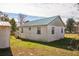 Rear of the home showing the exterior, yard, and storage shed at 24813 E Highway 316, Salt Springs, FL 32134