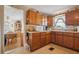 Cozy kitchen with wood cabinets, microwave, and eat-in area visible from doorway at 24813 E Highway 316, Salt Springs, FL 32134