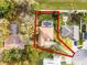 A bird's-eye view of the property with a screened pool, surrounded by lush greenery, outlined in red at 252 Longhirst Loop, Ocoee, FL 34761