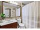 Bathroom featuring a dark wood vanity and a shower with striped curtain at 252 Longhirst Loop, Ocoee, FL 34761