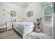 Bedroom featuring a white bed frame, bedside table, and decorative shelves at 252 Longhirst Loop, Ocoee, FL 34761