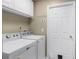 Practical laundry room features a full-size washer and dryer, and ample storage space at 252 Longhirst Loop, Ocoee, FL 34761