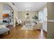 Cozy living room showcasing hardwood floors, neutral paint, a fireplace, and an archway to another room at 252 Longhirst Loop, Ocoee, FL 34761