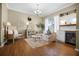 Inviting living room featuring hardwood floors, neutral paint, a fireplace, and a built-in bar area at 252 Longhirst Loop, Ocoee, FL 34761