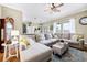 Inviting living room with a large sectional sofa, ceiling fan, and decorative accents at 252 Longhirst Loop, Ocoee, FL 34761